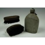 A Great War US Army water bottle together with a pair of Second World War British Army hairbrushes