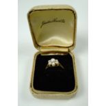 A 9 ct gold and pearl cluster set ring, having a central pearl set above six smaller stones on a