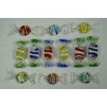 Twelve small studio glass decorative sweets in wrapper