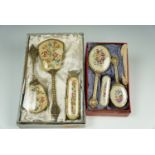 A Delina dressing table brush set together with a petit point four piece dresser set