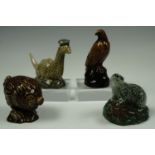 Four Beswick novelty whisky decanters respectively modelled as a badger, an eagle, the Loch Ness