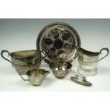 A pair of electroplate milk jugs and a pair of sugar bowls, together with an electroplate waiter and