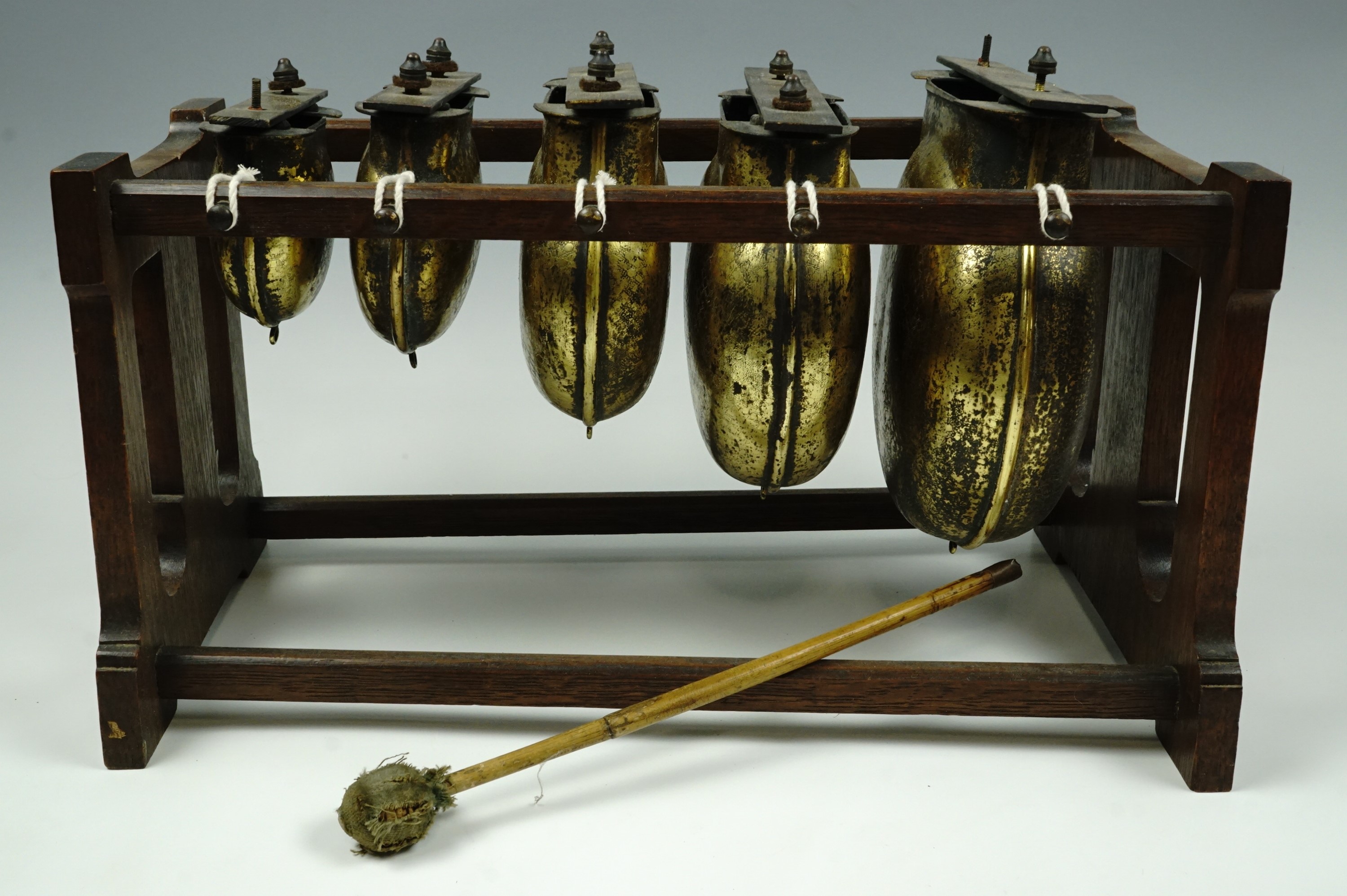 A late 19th Century idiophone type percussion musical instrument, comprising a graded set of brass