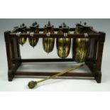 A late 19th Century idiophone type percussion musical instrument, comprising a graded set of brass