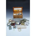 An oak jewellery box with a quantity of costume jewellery and three lady's wristwatches.