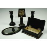 A late 19th / early 20th Century ebony dressing table set including a pair of candlesticks (15