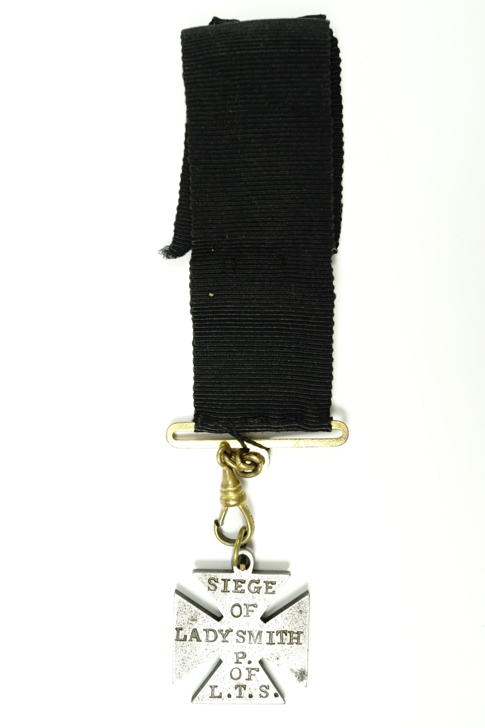 A Boer War period steel watch chain fob medallion in the form of a cross and bearing the struck