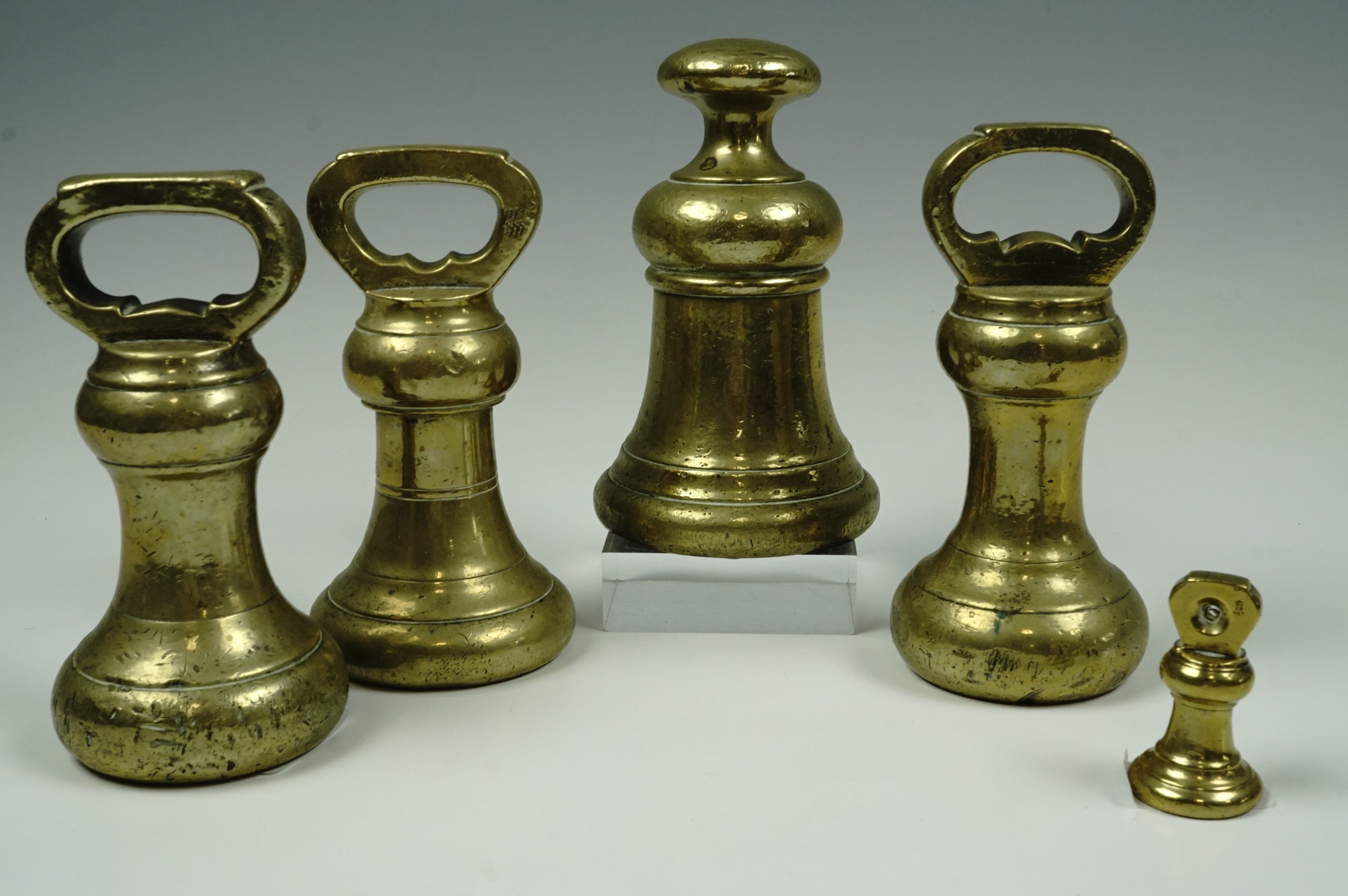 Five Victorian and later brass weights, tallest 16 cm