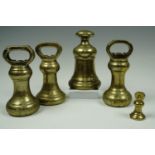 Five Victorian and later brass weights, tallest 16 cm
