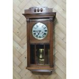 A 1920s - 1930s oak cased wall clock, 80 x 30 x 16 cm