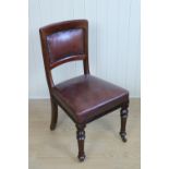 A set of four late Victorian hide-upholstered mahogany dining chairs