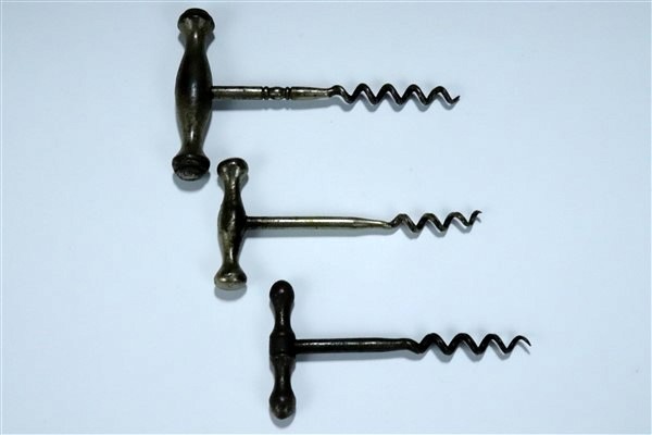 Two late 19th / early 20th Century cast steel combination corkscrews / tools together with three - Image 3 of 3