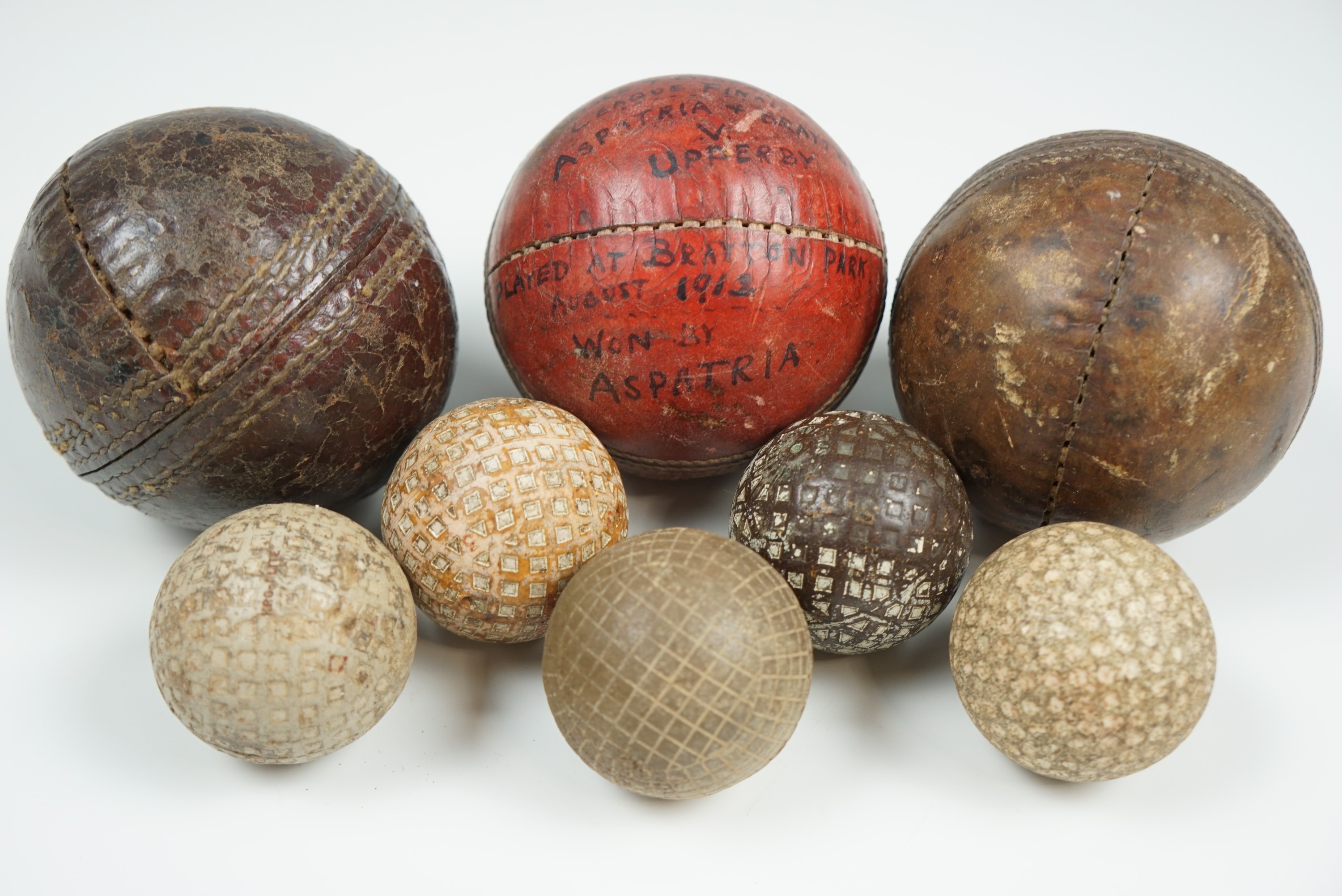 An Edwardian inscribed cricket ball, "Aspatria and Brayton v. Upperby", August 1913, two similar