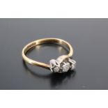 A vintage three-stone white sapphire ring, the three stones platinum illusion twist set on an 18