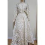 A vintage wedding dress in "Studholmes of Carlisle" carton