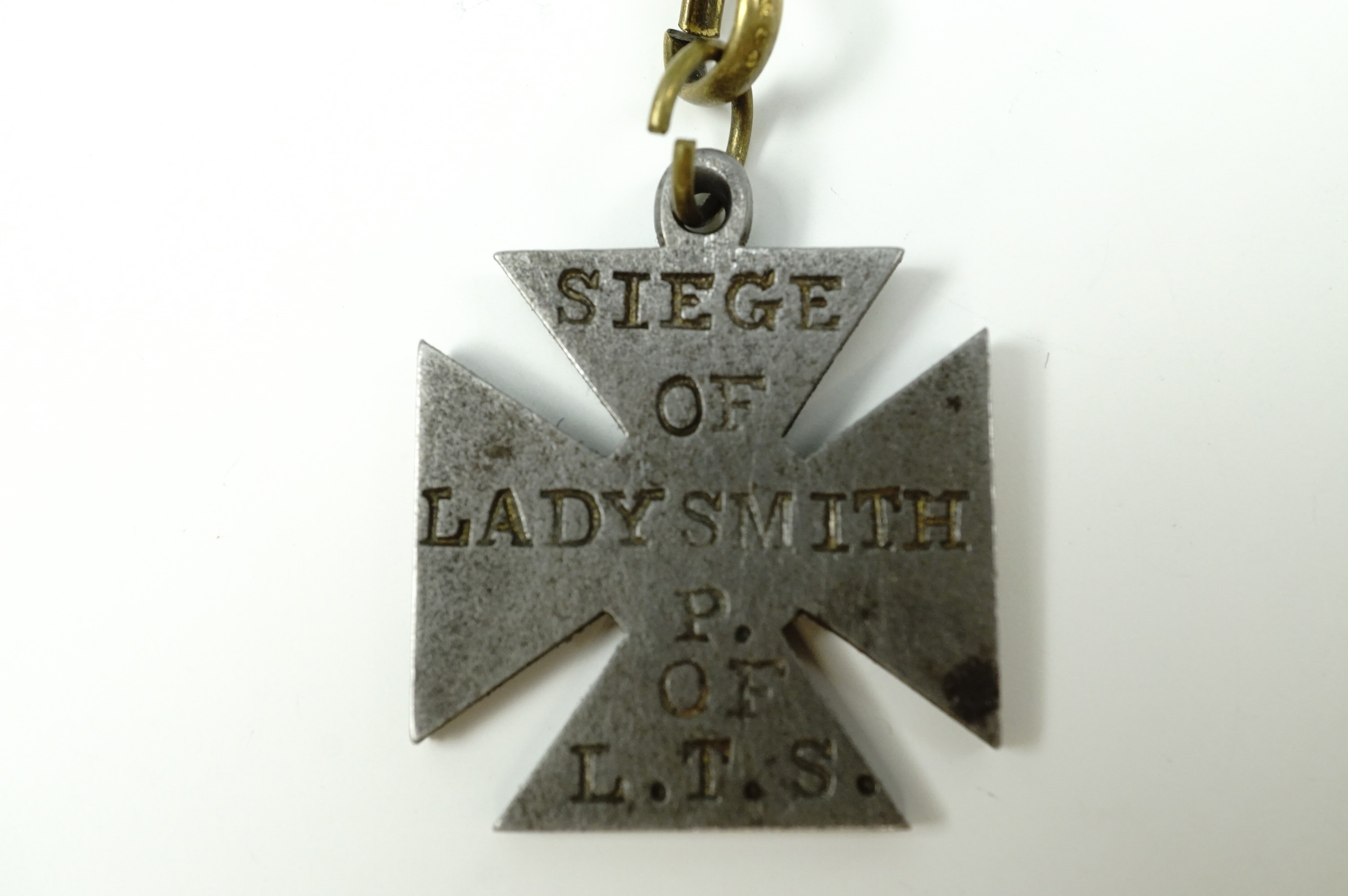 A Boer War period steel watch chain fob medallion in the form of a cross and bearing the struck - Image 2 of 3