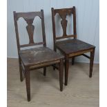 A set of six provincial oak dining chairs having tapered square legs and plain baluster back spat