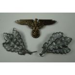 German Jager oakleaf cap badges together with an SS style cap eagle