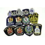 A quantity of antipodean police items, comprising New Zealand police cap and helmet badges,