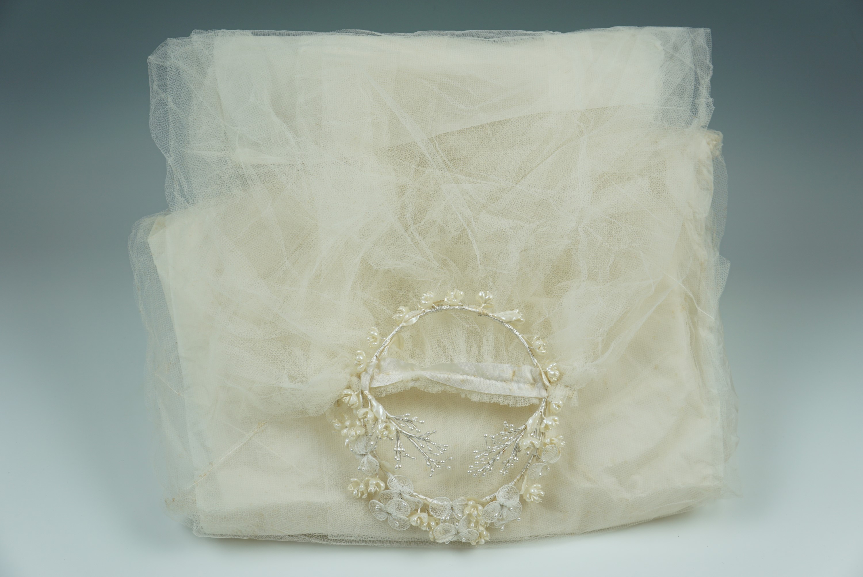 A vintage gauze and faux pearl flower head wedding veil