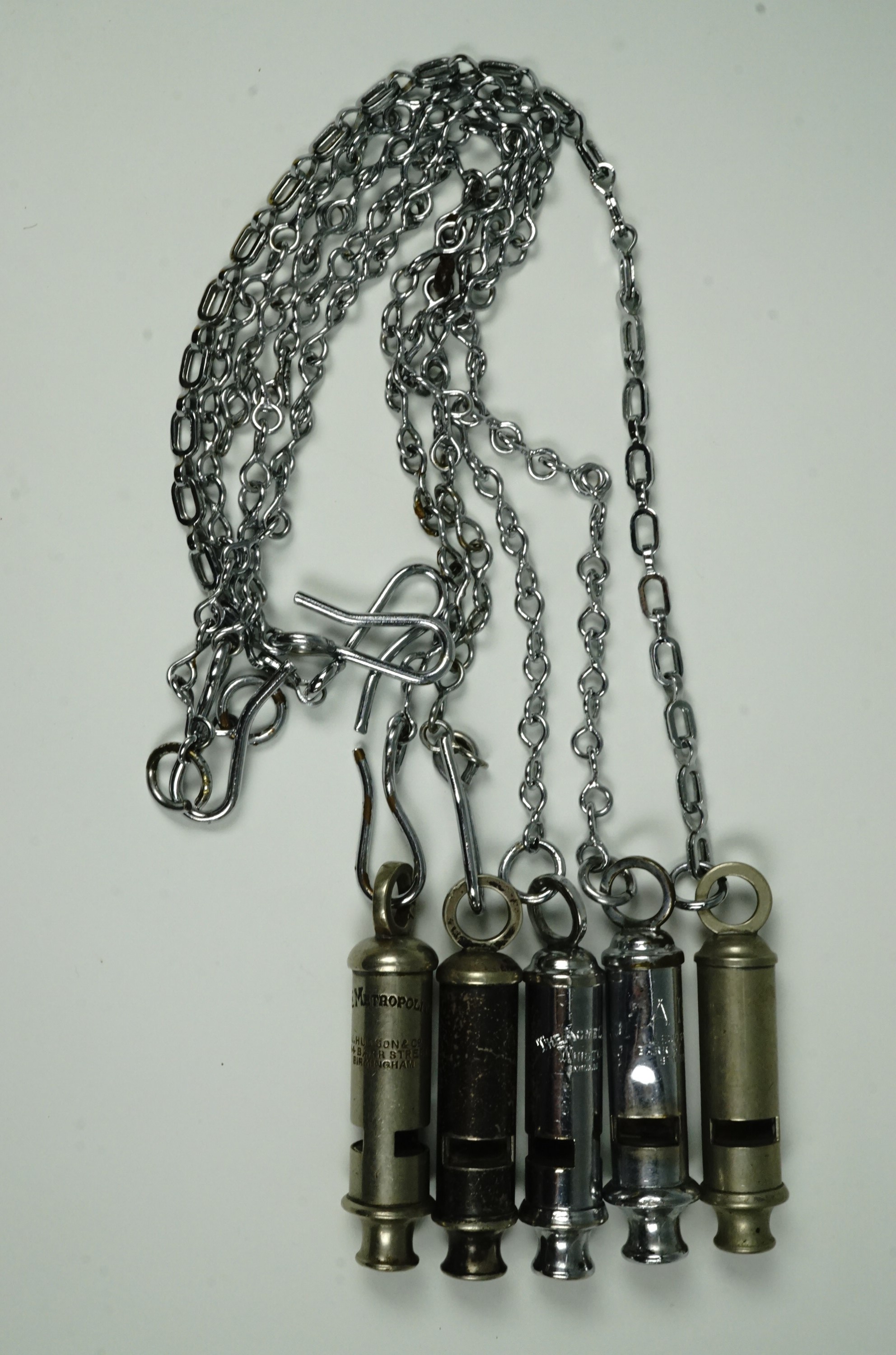 Five police whistles with chains, comprising 'ARP' whistle by Hudson and Co., 'The Metropolitan' - Image 2 of 3