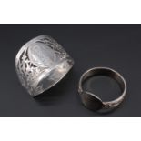 Two silver napkin rings, comprising Celtic strap-work band and a vacant round cartouche,