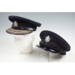 Two Royal Hong Kong police hats, one with braided brim.