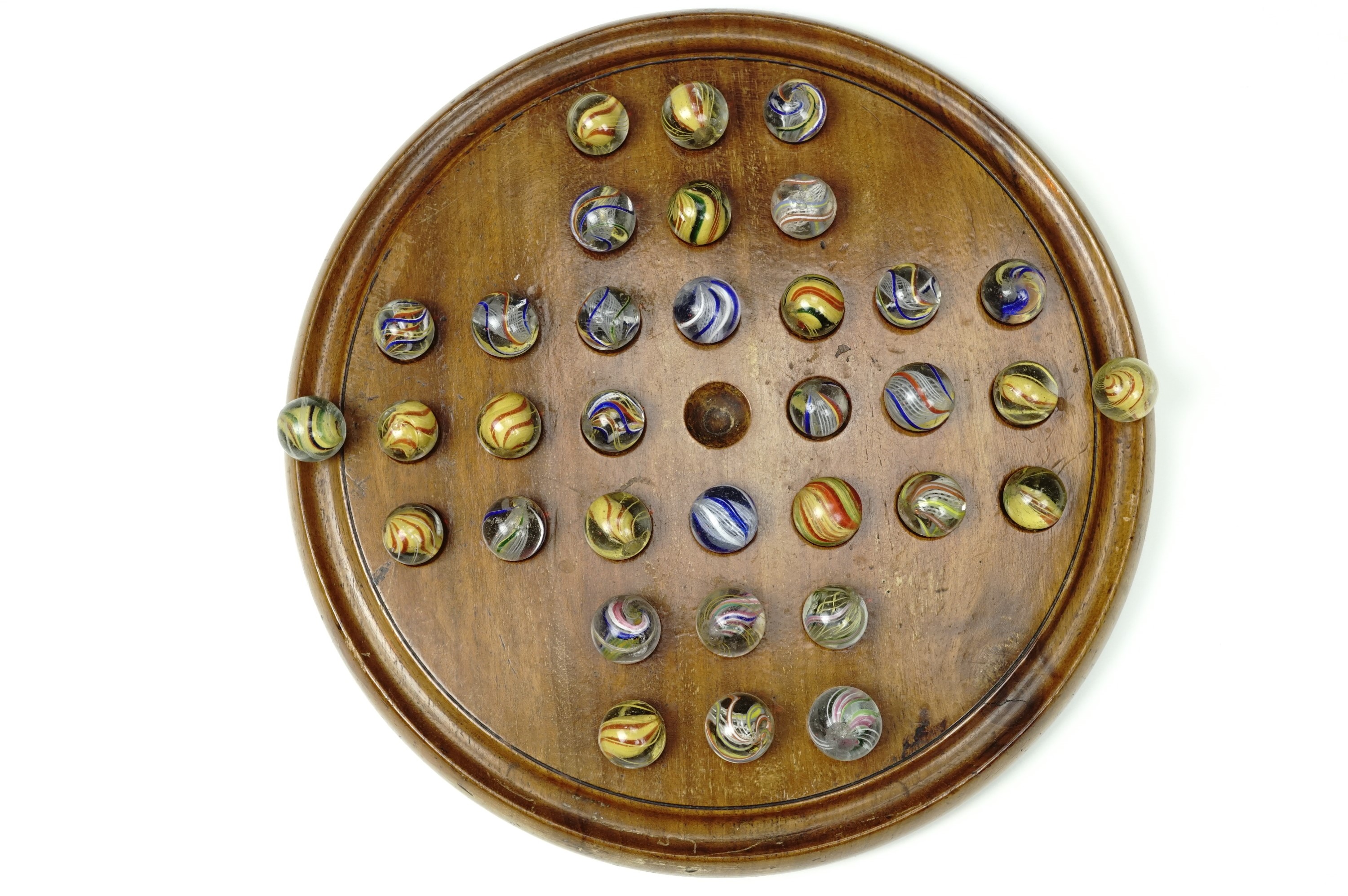 A late 19th Century turned mahogany Solitaire board and a good collection of glass marbles including