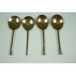 Three 16th - 17th Century style brass seal top spoons stamped to the bowls with a fleur-de-lys and a