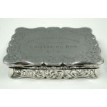 A Victorian silver snuff box, of fancy cusped form, profusely foliate scroll engraved, its hinged
