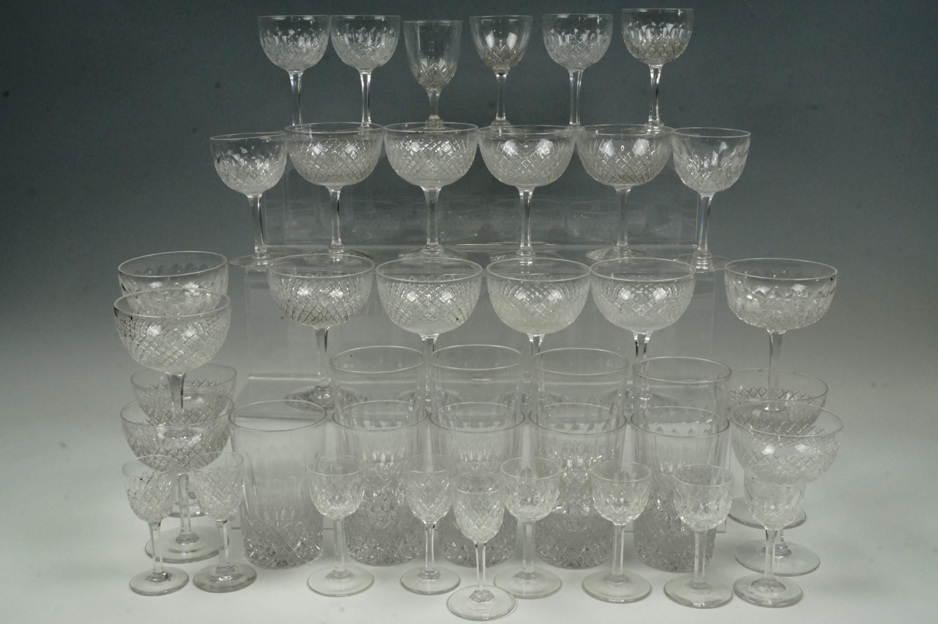 A large quantity of late 19th / early 20th Century drinking glasses, facet-cut in a cross-cut-
