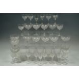 A large quantity of late 19th / early 20th Century drinking glasses, facet-cut in a cross-cut-
