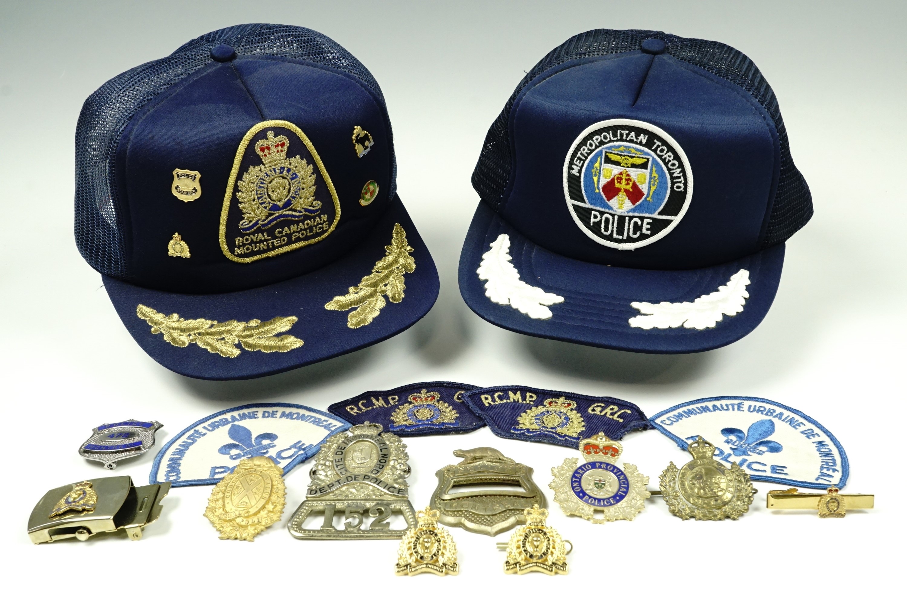 A collection of Canadian Police cap badges, comprising Montreal Police, Ontario Police, Royal
