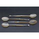 A collection of four Edwardian Scottish silver mounted horn spoons, vacant shield shaped escutcheons