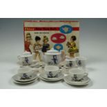 A boxed hand decorated toy tea set
