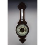 A late Nineteenth Century carved oak aneroid banjo barometer, 79 cm