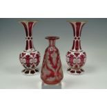 A pair of mid Nineteenth Century Bohemian style cased ruby glass vases together with a ruby flashed,