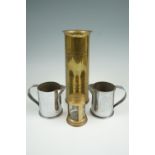 Two Great War trench art shell case jugs, together with a trench art vase and a money box, vase 28