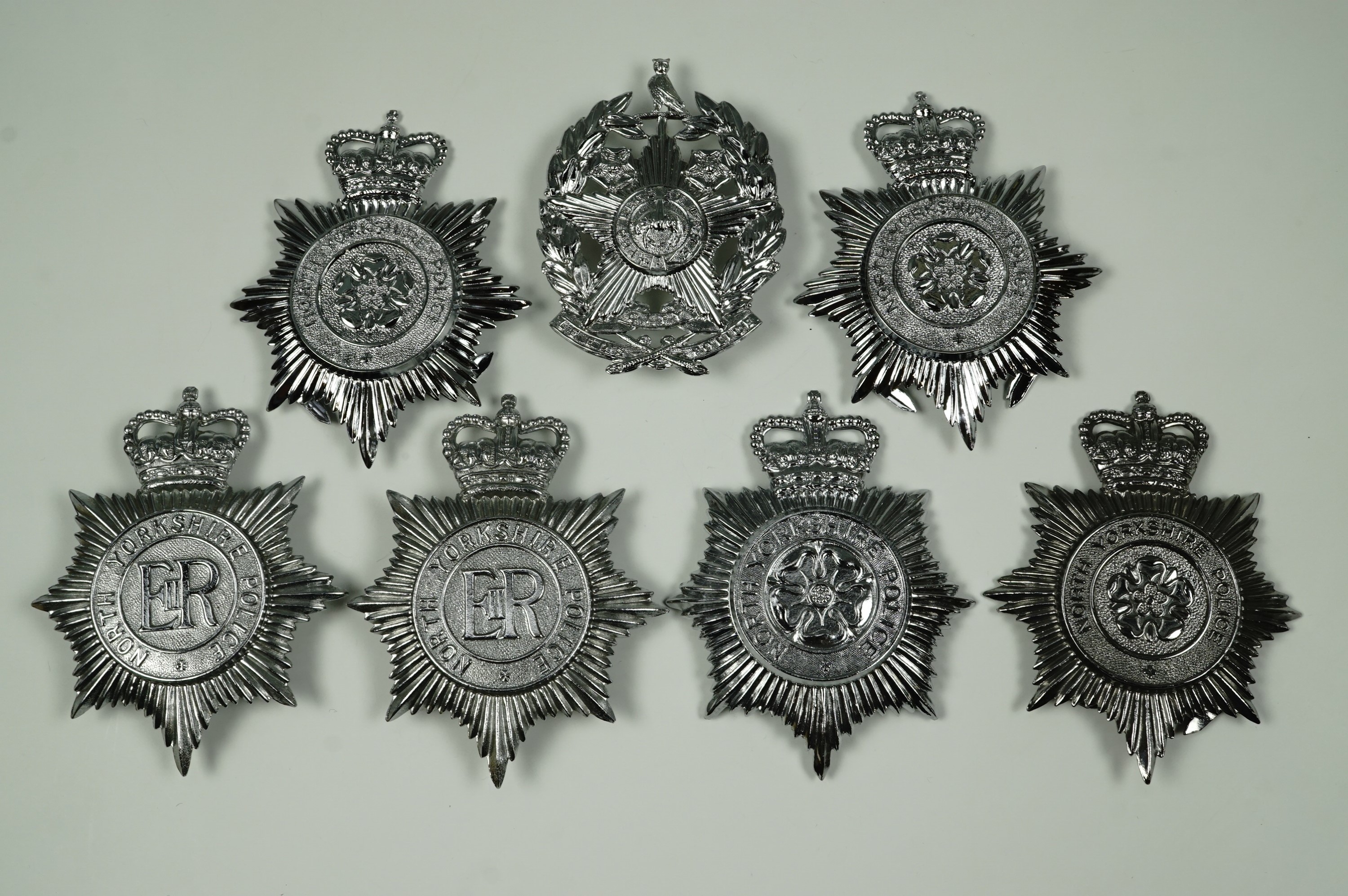 A collection of British police helmet plates, comprising varied designs of North Yorkshire Police,