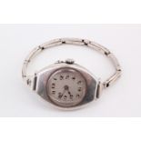 A 1917 silver wristlet watch, having a Swiss pin-set movement and tonneau shaped case with