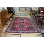 A large Persian wool and silk blend Shiraz rug, 286 x 215 cm