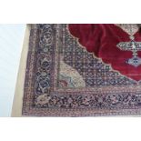 A large Persian hand knotted wool rug, approximately 430 x 320 cm