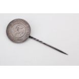 A stick pin formed from a young head Victoria shilling with its reverse face polished and