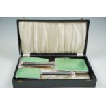 A cased dressing table set, in chrome plate and faux green guilloche enamel, circa 1940s