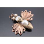 A Victorian pearl and yellow metal bug brooch, modelled as a stylized bee or similar insect, its