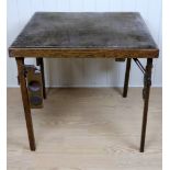 A Stakmore folding oak card table with integral counter dishes, 76 x 76 x 70 cm
