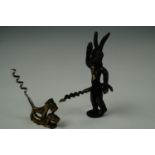 An Art Deco corkscrew, its handle in the form of a pair of dogs, circa 1930s, together with one