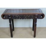 A fine Chinese carved haunghuali / hardwood recessed-leg yi zi zhuo shi table, the scroll ends and