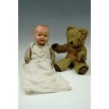 A 1950s golden plush Teddy bear by Wendy Boston, 35 cm, together with a fabric bodied doll having