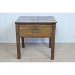 An Edwardian oak lamp or low table with single drawer, having a campaign style inset brass handle,